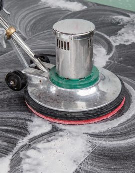 Thai people cleaning black granite floor