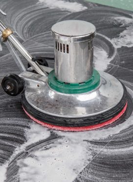 Thai people cleaning black granite floor