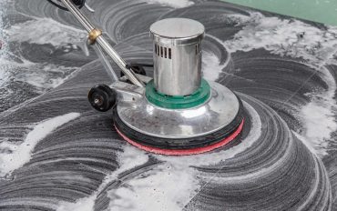 Thai people cleaning black granite floor