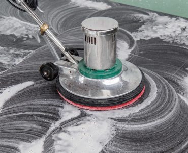 Thai people cleaning black granite floor