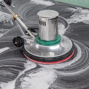 Thai people cleaning black granite floor